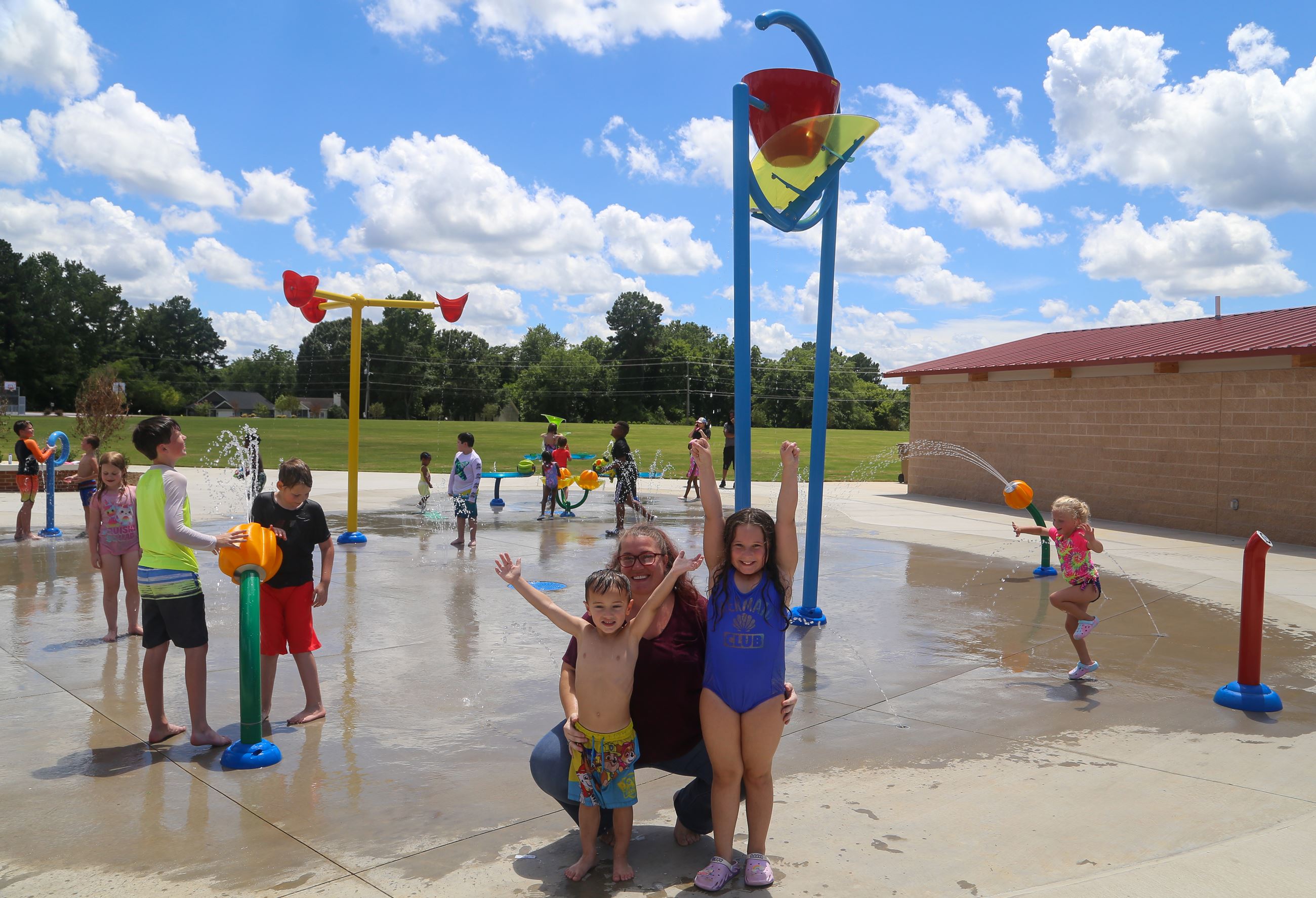 Erika Hale and her two children, Tessa-R and William-L, enjoying the splash pad